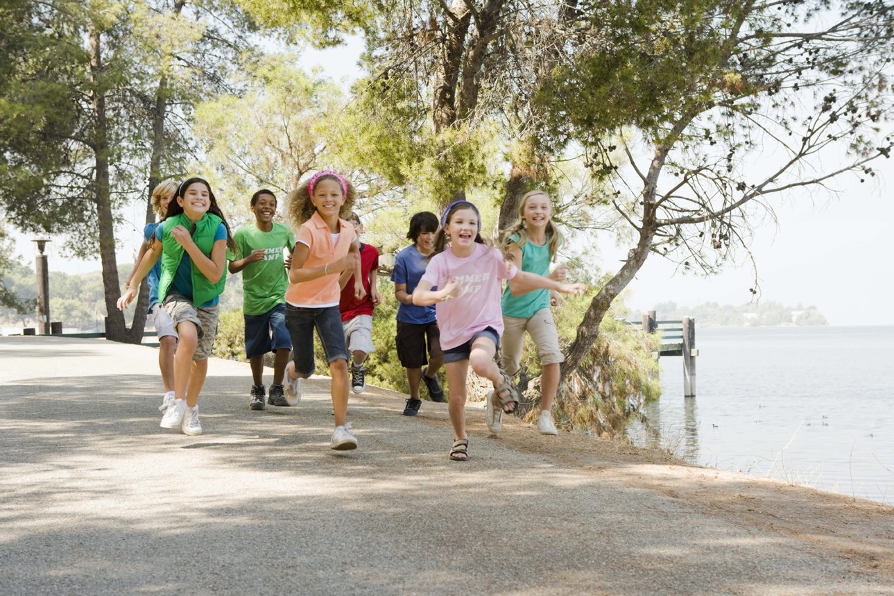 Children running together outdoors at a community event