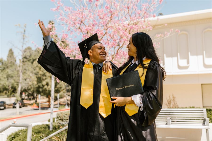 Graduates in caps and gowns celebrating together