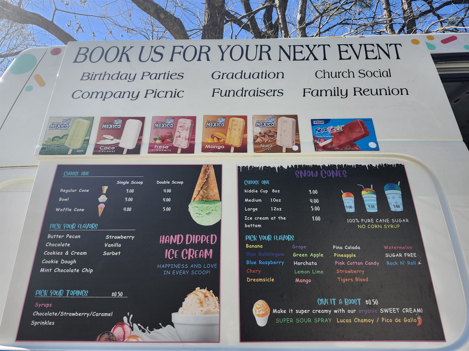 The side of an NC Ice Cream truck showing its full menu boards