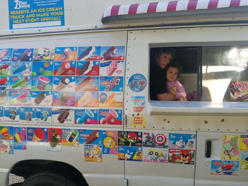 Server handing ice cream through the NC Icecream truck window